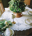 Elegant table setting with floral centerpieces and white tablecloth